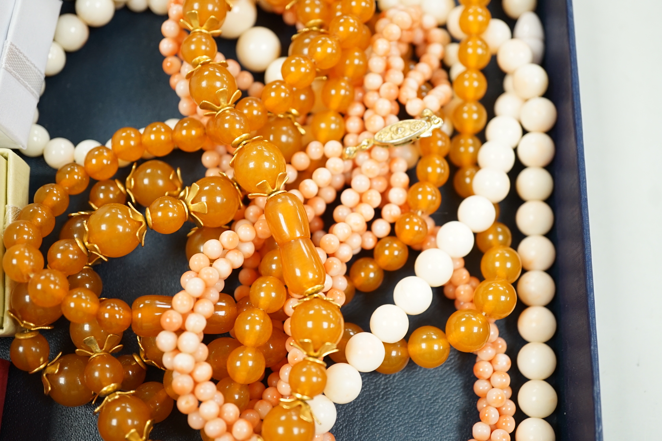 A 9ct and opal doublet ring, two other 9ct and gem set rings, an Edwardian yellow metal and swivelling carnelian ring and six assorted necklaces.